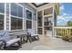 Inviting screened porch with comfortable rocking chairs, a small table, and views of the yard at 664 Old Dairy Dr, Wake Forest, NC 27587