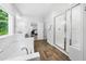 Bathroom with walk-in shower, soaking tub, and views into the bedroom at 7301 Villoria Ln, Raleigh, NC 27617