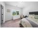 Bedroom with neutral carpet, window, dresser, and a comfortable bed at 7301 Villoria Ln, Raleigh, NC 27617