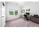 Well-lit bedroom with large window, neutral carpet, and a comfortable work space at 7301 Villoria Ln, Raleigh, NC 27617