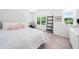 Bright bedroom featuring plush carpet, natural light from windows, and elegant decorative ladder at 7301 Villoria Ln, Raleigh, NC 27617