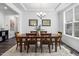 Elegant dining room featuring a classic chandelier, wood table with seating for six, and tray ceiling at 7301 Villoria Ln, Raleigh, NC 27617