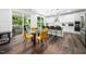 Modern eat-in kitchen featuring a glass table, bar seating, stainless steel appliances, and backyard access at 7301 Villoria Ln, Raleigh, NC 27617