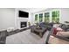 Inviting living room with a fireplace, a comfortable sectional sofa, and large windows with natural light at 7301 Villoria Ln, Raleigh, NC 27617