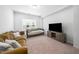 Cozy living room with comfortable seating, a daybed, and TV entertainment center at 7301 Villoria Ln, Raleigh, NC 27617