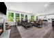 Bright living room featuring large windows, a comfortable sectional sofa, and hardwood flooring at 7301 Villoria Ln, Raleigh, NC 27617