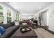 Spacious living room with an open floor plan leading to a modern kitchen and staircase at 7301 Villoria Ln, Raleigh, NC 27617