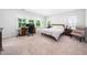 Spacious main bedroom with a work space, bed and bedside tables at 7301 Villoria Ln, Raleigh, NC 27617