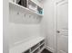 Bright mudroom with coat hooks, built-in bench with storage, and upper shelving at 7301 Villoria Ln, Raleigh, NC 27617