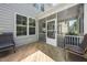 Covered back porch with cozy seating and views of the well-maintained yard, perfect for outdoor relaxation at 7301 Villoria Ln, Raleigh, NC 27617