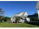 A spacious backyard featuring a screened-in porch, a deck, and lush green grass under a clear blue sky at 759 Wheeler Dr, Angier, NC 27501