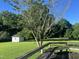 Inviting backyard scene with a rustic deck, lush greenery, and storage shed, offering serene outdoor space at 759 Wheeler Dr, Angier, NC 27501