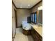 Bathroom features a soaking tub, wooden cabinets, and a window providing natural light at 759 Wheeler Dr, Angier, NC 27501