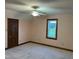 A spacious bedroom with plush carpeting, a dark wooden door, and a bright window at 759 Wheeler Dr, Angier, NC 27501