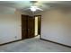 Bedroom featuring neutral carpet, light pink walls, and a dark wood door to another room at 759 Wheeler Dr, Angier, NC 27501