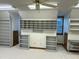 Spacious bonus room featuring large built-in shelving with countertops and neutral carpet at 759 Wheeler Dr, Angier, NC 27501