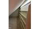Triangular shaped walk-in closet with multiple built-in shelves and carpet at 759 Wheeler Dr, Angier, NC 27501