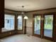 Eat-in kitchen featuring a chrome chandelier and windows overlooking the back yard at 759 Wheeler Dr, Angier, NC 27501