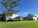 Rear exterior view of home with expansive lawn, detached garage and screened porch at 759 Wheeler Dr, Angier, NC 27501