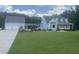 Charming home featuring a lush green lawn, two-car garage, and connecting walkway at 759 Wheeler Dr, Angier, NC 27501