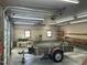 Spacious garage interior with ample lighting, equipped for storage and projects, featuring a vintage trailer at 759 Wheeler Dr, Angier, NC 27501