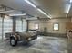 Spacious garage interior with ample lighting, equipped for storage and projects, featuring a vintage trailer at 759 Wheeler Dr, Angier, NC 27501