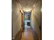 Hallway featuring wood floors and decorative trim leading to the kitchen at 759 Wheeler Dr, Angier, NC 27501