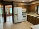 Spacious kitchen with white appliances and view to an adjacent sitting room at 759 Wheeler Dr, Angier, NC 27501