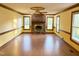 Spacious living room with brick fireplace, wood floors and natural light at 759 Wheeler Dr, Angier, NC 27501