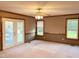 Living room with ceiling fan, wood floors and access to the backyard at 759 Wheeler Dr, Angier, NC 27501
