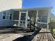 Enclosed porch with wooden railing at 759 Wheeler Dr, Angier, NC 27501