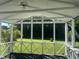 Cozy screened-in porch with scenic views of the lush green lawn and surrounding trees at 759 Wheeler Dr, Angier, NC 27501