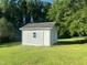 Small storage shed in backyard, providing a practical storage and organization solution for tools and equipment at 759 Wheeler Dr, Angier, NC 27501
