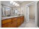 Bathroom featuring double sink vanity with granite countertop, wood cabinets, a large mirror, and tile flooring at 80 Scarlet Bell Dr, Youngsville, NC 27596