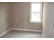 Bright bedroom with neutral walls and carpet, illuminated by a window offering natural light at 80 Scarlet Bell Dr, Youngsville, NC 27596