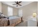 Cozy bedroom featuring a ceiling fan and a window with sheer curtains at 80 Scarlet Bell Dr, Youngsville, NC 27596