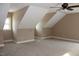 Bonus room featuring angled ceilings, a ceiling fan, and ample space at 80 Scarlet Bell Dr, Youngsville, NC 27596