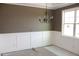 Dining room with wainscoting and an elegant chandelier, creating a sophisticated ambiance at 80 Scarlet Bell Dr, Youngsville, NC 27596