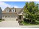 Charming home with manicured lawn, dormer windows, neutral siding, and an attached two-car garage at 80 Scarlet Bell Dr, Youngsville, NC 27596