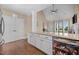Modern kitchen showcasing a granite countertop island, white cabinets, stainless steel appliances, and hardwood flooring at 80 Scarlet Bell Dr, Youngsville, NC 27596