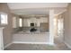 Bright kitchen featuring white cabinets, stainless steel appliances, and a granite countertop bar at 80 Scarlet Bell Dr, Youngsville, NC 27596