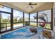 Relaxing screened-in porch with a hanging chair and comfortable seating at 80 Scarlet Bell Dr, Youngsville, NC 27596