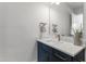 Stylish bathroom featuring a navy blue vanity, quarts countertop and decorative mirror at 808 Shiloh Hills Dr, Fuquay Varina, NC 27526