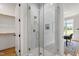 Modern bathroom featuring a glass-enclosed shower with white tile surround and gold hardware at 808 Shiloh Hills Dr, Fuquay Varina, NC 27526