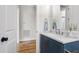 Stylish bathroom vanity with blue cabinet, marble countertop, and gold fixtures at 808 Shiloh Hills Dr, Fuquay Varina, NC 27526