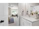 Bright bathroom with white vanity, stone countertop, and a view into the bedroom at 808 Shiloh Hills Dr, Fuquay Varina, NC 27526