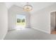 Spacious room featuring a vaulted ceiling, large window, and modern light fixture at 808 Shiloh Hills Dr, Fuquay Varina, NC 27526