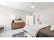 Comfortable bedroom with neutral tones, ceiling fan, and a stylish wooden dresser at 808 Shiloh Hills Dr, Fuquay Varina, NC 27526