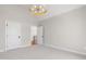 Spacious room featuring a vaulted ceiling, modern light fixture and an ensuite bathroom at 808 Shiloh Hills Dr, Fuquay Varina, NC 27526