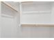 Walk in closet with white walls and wooden closet rods for ample storage at 808 Shiloh Hills Dr, Fuquay Varina, NC 27526